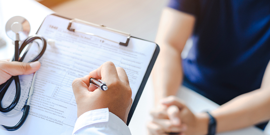 Doctor reviewing paperwork with patient