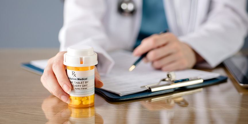 Doctor holding medication bottle.