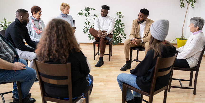 Support group gathered together in a circle