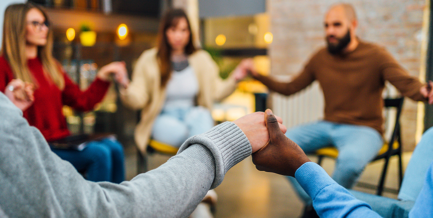 Support group joined together holding hands