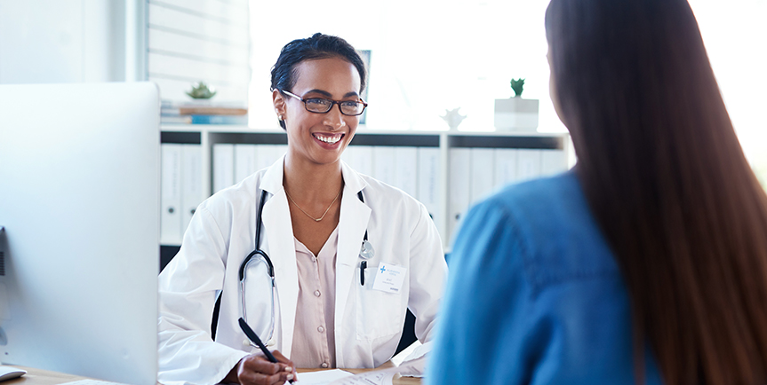 Smiling doctor speaking with a patient