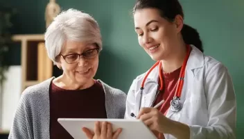 A doctor shows a woman her chart